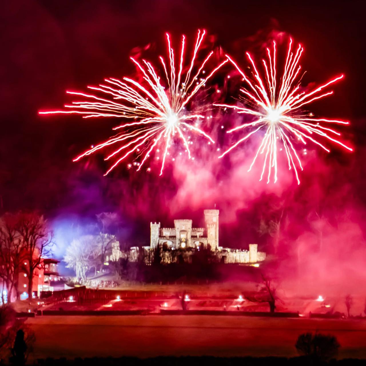 Pink fireworks above a castle